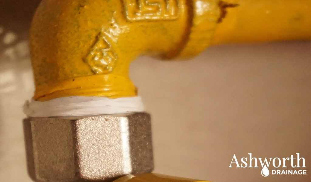 Ashworth drainage logo, yellow iron water pipe with fitting and loc-tight tape